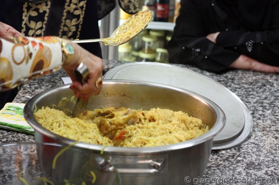 After the rice was cooked for 10 minutes in the oven, the chicken pieces are returned to the pot