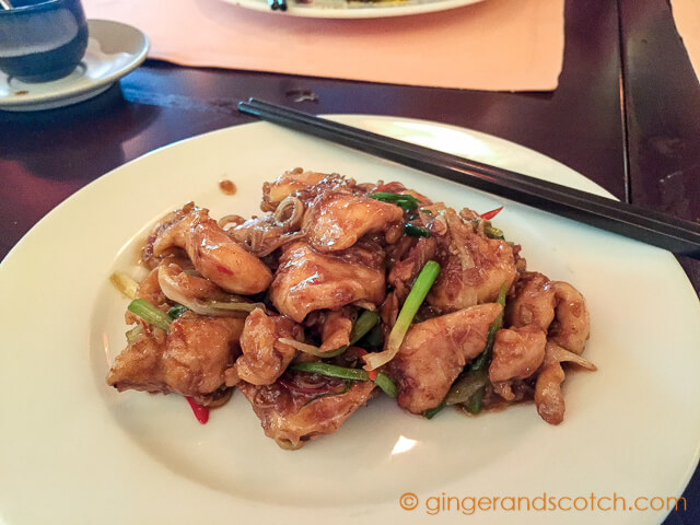 Clay pot of wok-fried organic chicken with lemongrass, chili, onions, and X.O. sauce